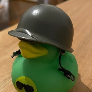 Ken’s a miniature or replica M1 style combat helmet, a toy or accessory for